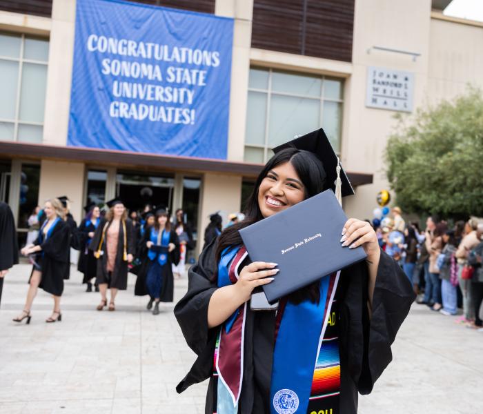 student smiling at commencement