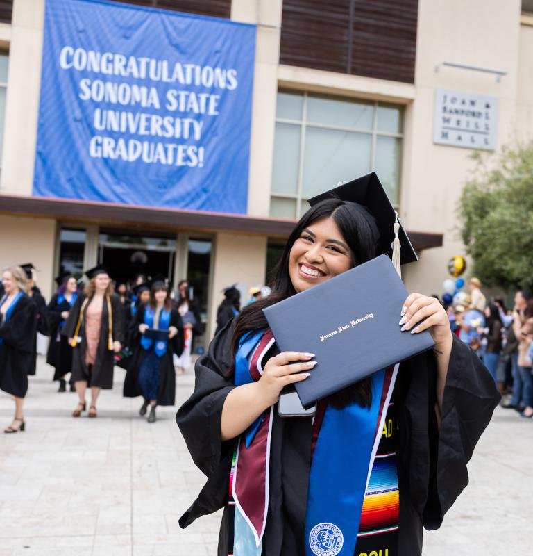 student smiling at commencement