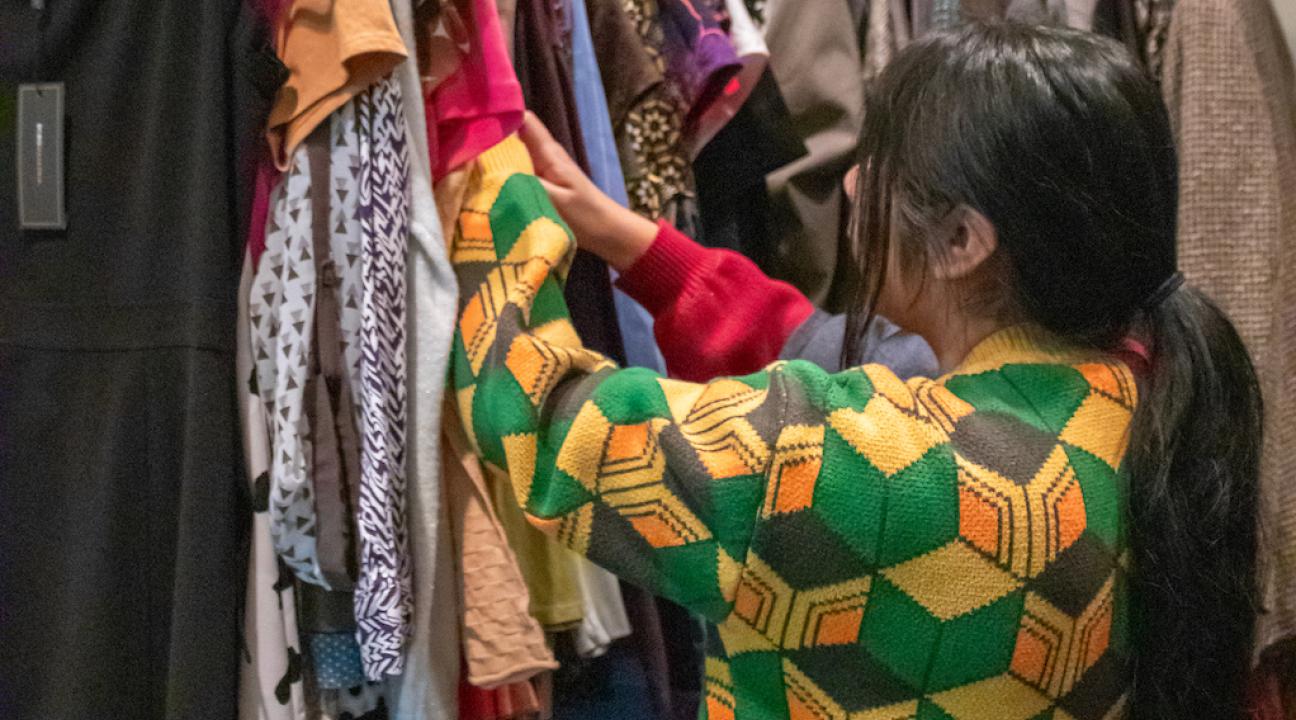 student looking through closes in career closet 