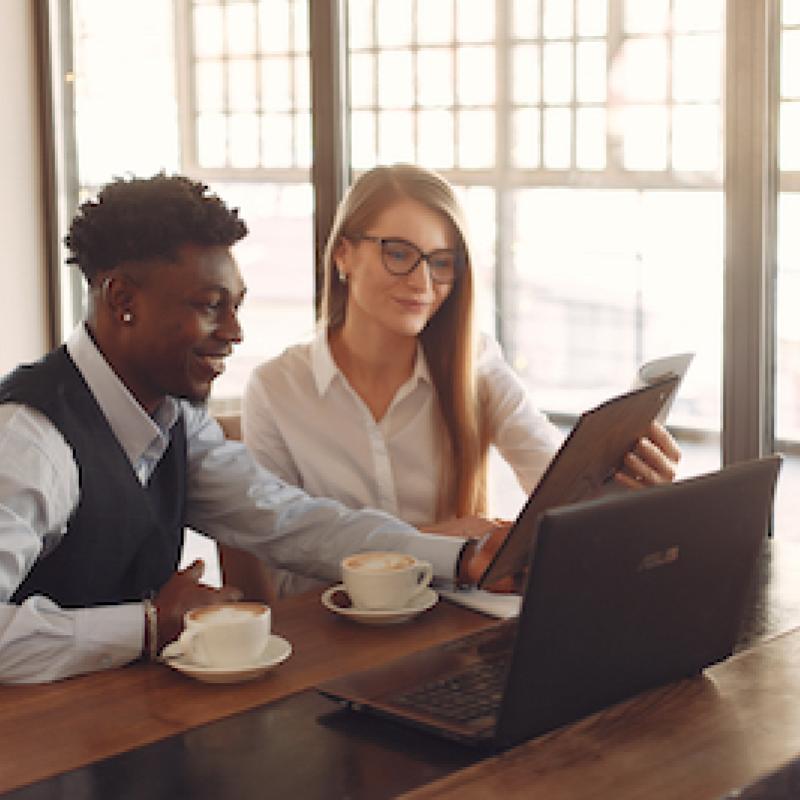two people working collaboratively at a desk