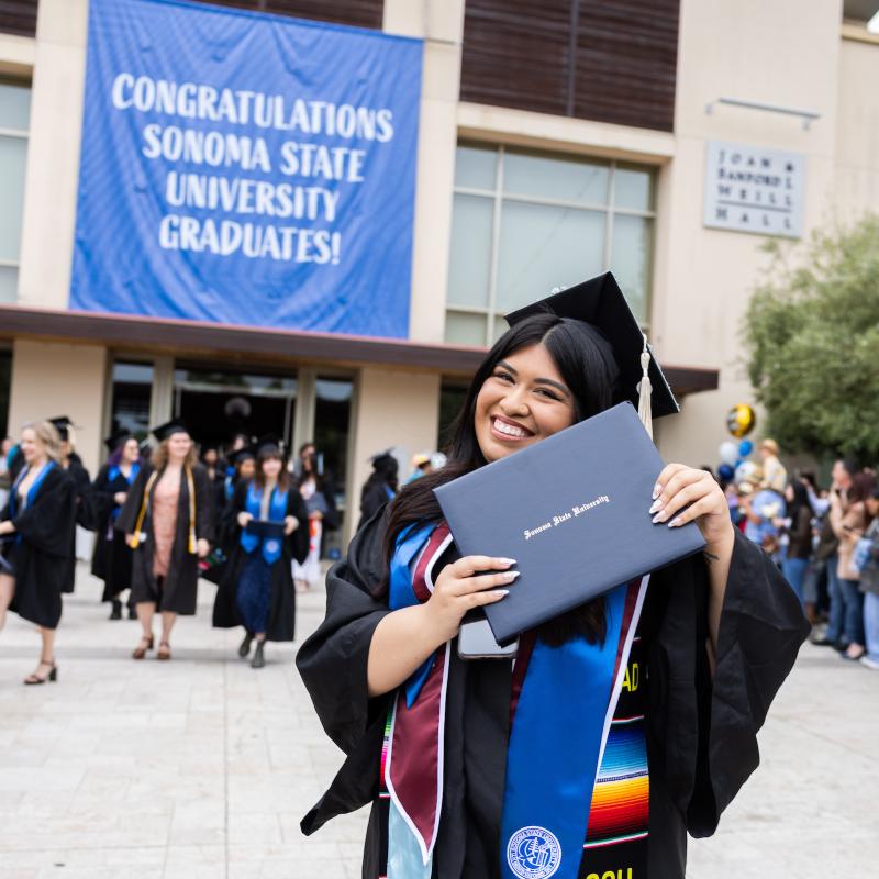 student smiling at commencement