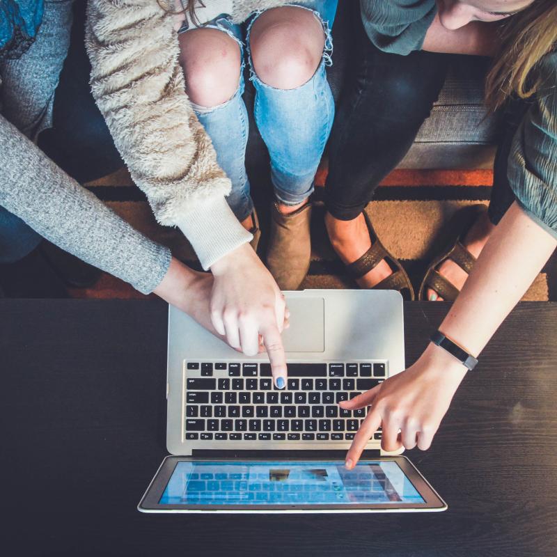 three students work collaboratively on a computer