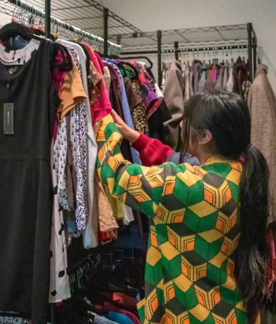 student looking through closes in career closet 